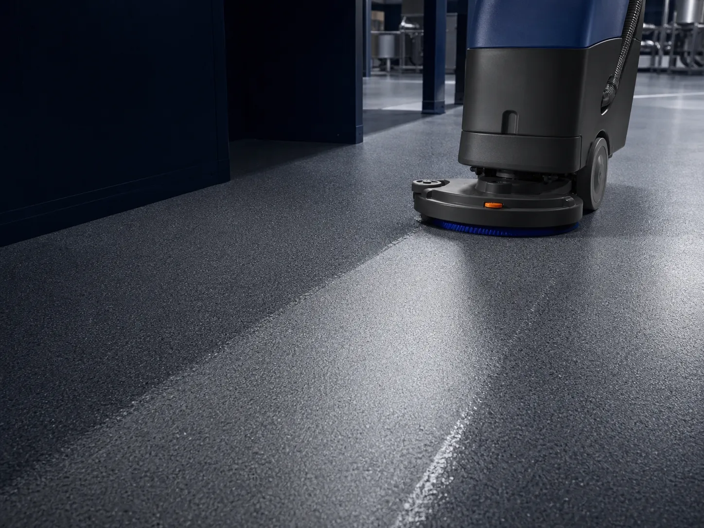 Professional scrubber cleaning a textured anti-slip resin floor while preserving the visible surface profile