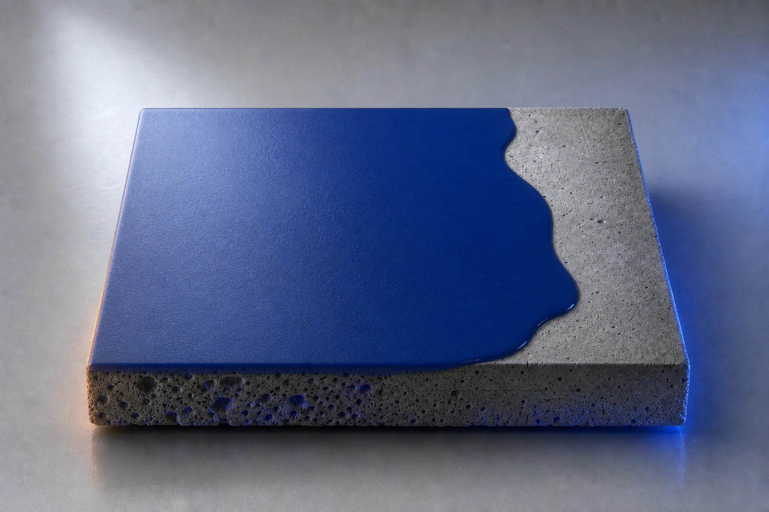 Deep blue resin coating flowing across prepared concrete to create a continuous seamless floor finish