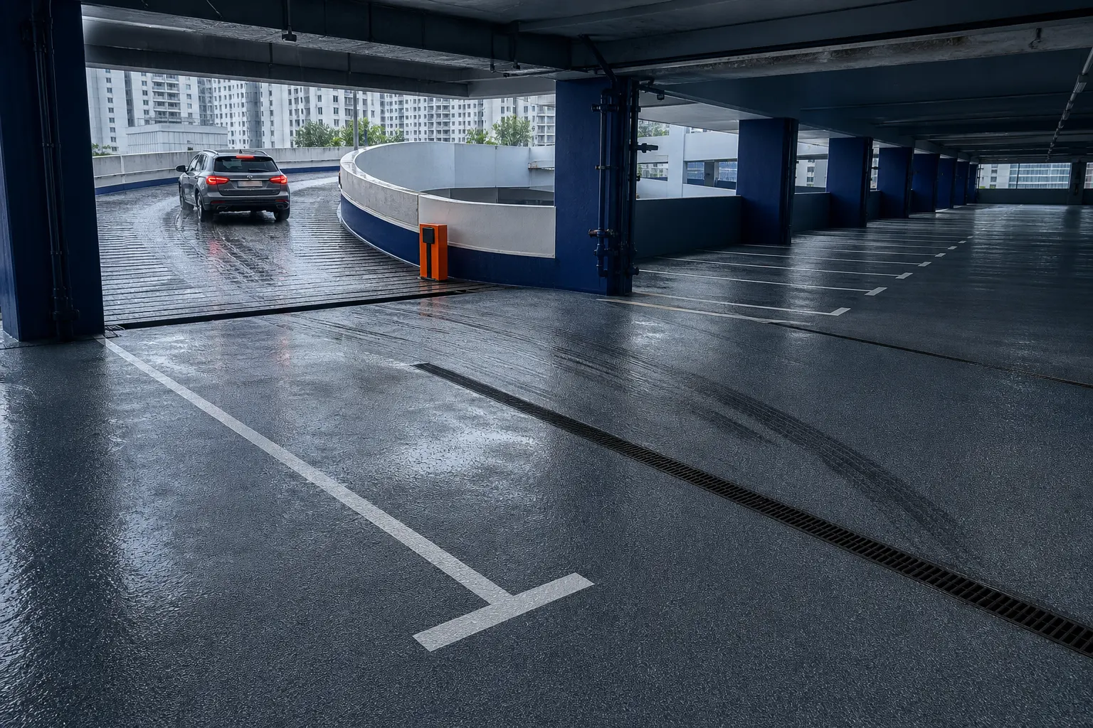 Rain-wet multi-storey car park deck showing tyre traffic, anti-slip ramp texture and drainage