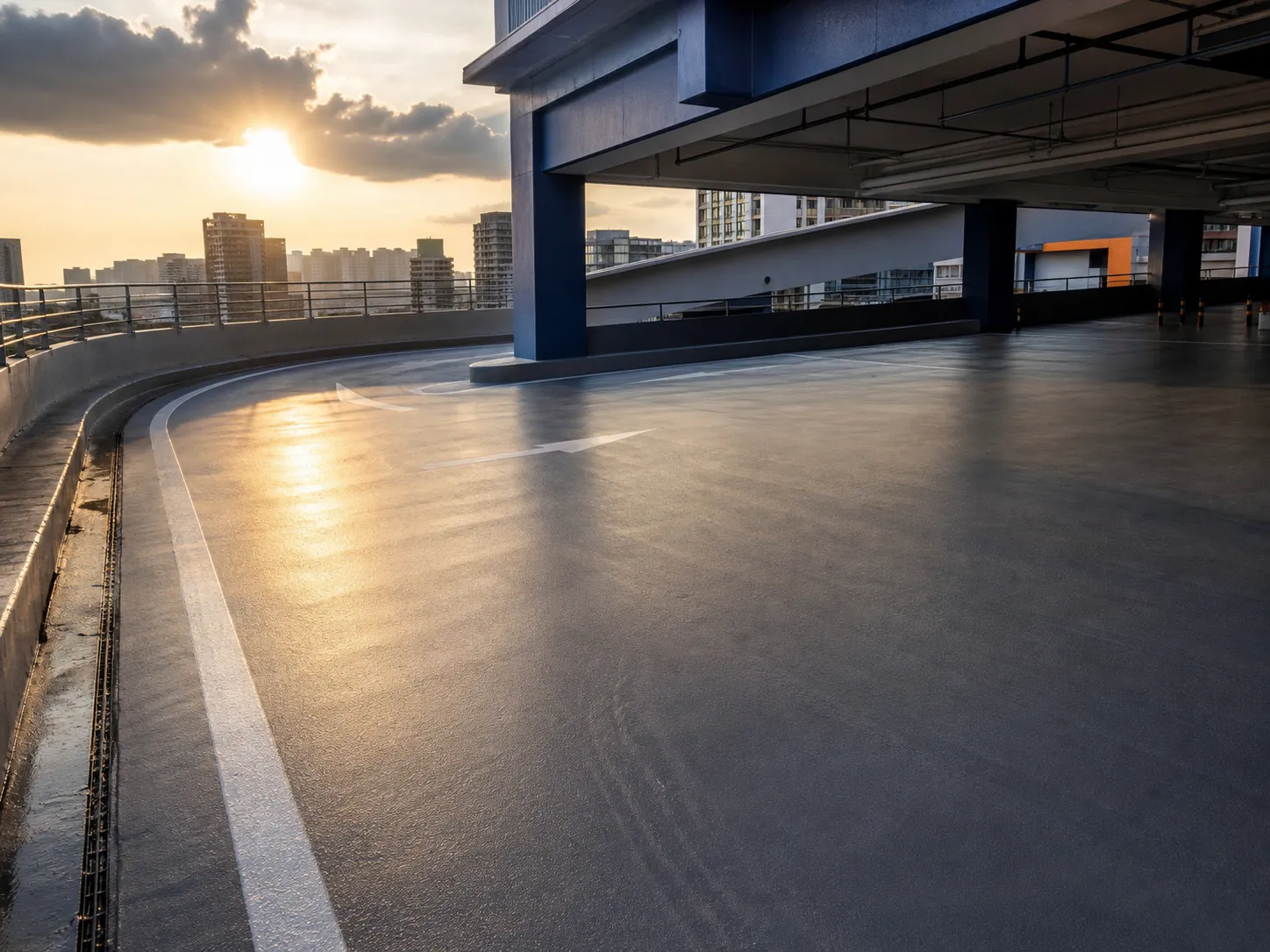 Sunlit upper car-park deck with a continuous polyurethane-coated traffic surface and drainage edge