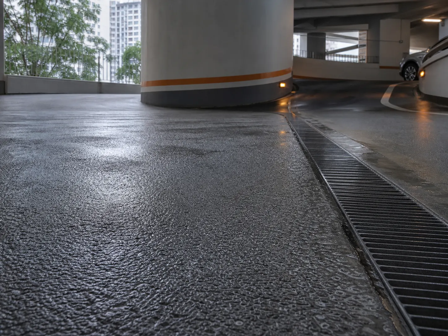Wet anti-slip car-park ramp directing runoff to a drain